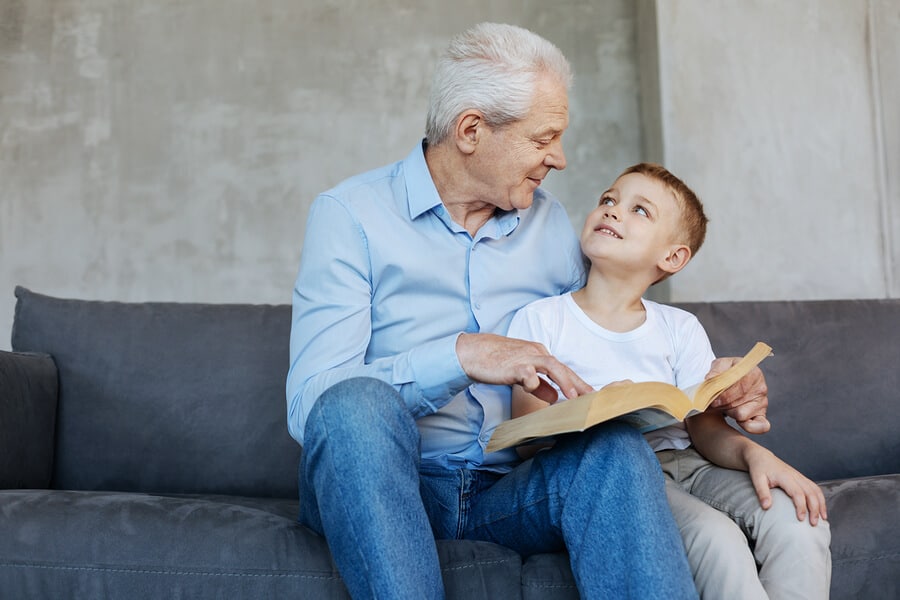 Grandfather teaching grandson how to read